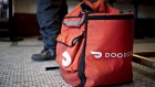 A DoorDash Inc. delivery bag sits on the floor at Chef Geoff's restaurant in Washington, D.C., U.S., on Thursday, March 26, 2020. As the wheels of government turn too slowly for small businesses desperate for a piece of the $2 trillion U.S. relief package due to the coronavirus pandemic, restaurateur Geoff Tracy is using GoFundMe to raise money for 150 hourly workers at his American comfort food standby Chef Geoff's and other restaurants. Photographer: Andrew Harrer/Bloomberg