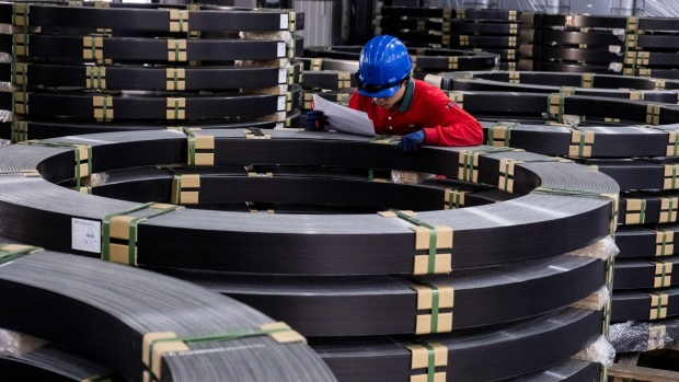 A worker checks the carbon-fiber composite made for wind blades stored at the Swancor Holding Co., factory in Nantou, Taiwan, on Monday, Feb. 19, 2024. Swancor is one of several firms globally trying to develop new products that mimic the physical properties of current blade material but can be chemically recycled. Photographer: Lam Yik Fei/Bloomberg