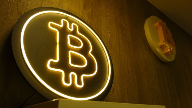 A neon Bitcoin cryptocurrency logo at a crypto exchange kiosk in Warsaw, Poland, on Thursday, March 14, 2024. Bitcoin extended a retreat from its latest record high amid an intensifying debate about whether the bull run in cryptocurrencies is evidence of speculative froth in global markets. Photographer: Damian Lemanski/Bloomberg
