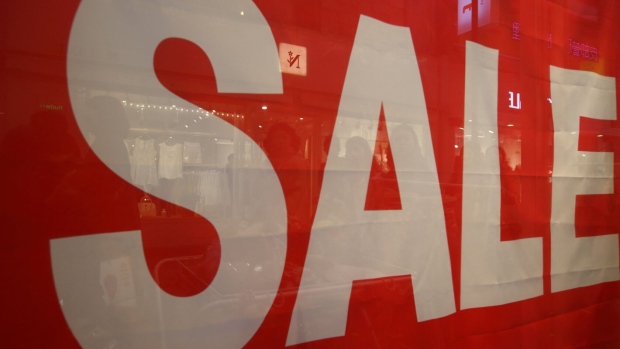 A sale sign is displayed in a store window. Photographer: SeongJoon Cho/Bloomberg 