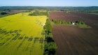 A canola field sits next to a plowed field in this aerial photograph taken above Orangeville