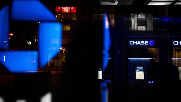 JPMorgan Chase & Co. signage is illuminated at night at a bank branch in Chicago, Illinois, U.S., on Tuesday, July 10, 2017. JPMorgan Chase & Co. is scheduled to release earnings figures on July 13. Photographer: Christopher Dilts/Bloomberg