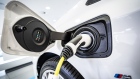 An electric charging plug sits connected to a BMW automobile inside a Bayerische Motoren Werke AG showroom in Frankfurt, Germany, on Tuesday, Aug. 4, 2020.
