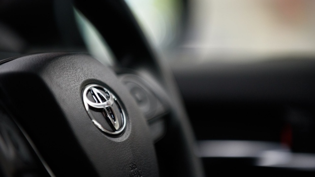 The Toyota Motor Corp. badge is seen on the steering wheel of a Camry vehicle displayed at the company's office in Tokyo, Japan, on Tuesday, Feb. 6, 2018. Toyota predicted a record profit this fiscal year helped in part by President Donald Trump’s tax cuts and surging sales of the updated Camry sedan and RAV4 sport-utility vehicle in the U.S. Photographer: Akio Kon/Bloomberg