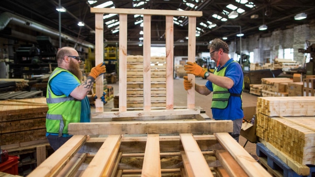 Employees move a non heat treated wooden pallet at Shaw Pallet Ltd. in Huddersfield, U.K., on Tuesday, Aug. 25, 2020. From January, wooden pallets moving goods between the U.K. and EU will need to comply with ISPM-15 -- an international rule that requires them to be baked to 56 degrees Celsius for at least 30 minutes to prevent the spread of pests and diseases. Photographer: Chris Ratcliffe/Bloomberg