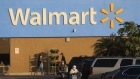 Shoppers wearing protective masks return to their vehicles outside a Walmart store in Duarte, California, U.S., on Thursday, Nov. 12, 2020. Walmart Inc. is scheduled to release earnings figures on November 17.