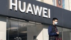 A pedestrian wearing a protective mask walks past a Huawei Technologies Co. store in Shanghai, China, on Monday, Jan. 18, 2021. The U.S. government notified several of Huawei's suppliers that it's revoking their licenses to work with the Chinese company and rejecting other applications in the last days of Donald Trump’s presidency, Reuters reported, citing unidentified people familiar with the matter. Photographer: Qilai Shen/Bloomberg