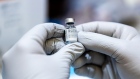 A healthcare worker holds a vial of the Pfizer-BioNTech Covid-19 vaccine at the Sun City Anthem Community Center vaccination site in Henderson, Nevada, U.S., on Thursday, Feb. 11, 2021.