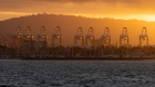 Gantry cranes at sunset at the Port of Long Beach in Long Beach, California. Photographer: Bing Guan/Bloomberg