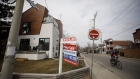 A "Sold" sign on a front lawn of a home in the York neighborhood of Toronto, Ontario, Canada, on Thursday, March 11, 2021. The buying, selling and building of homes in Canada takes up a larger share of the economy than it does in any other developed country in the world, according to the Bank of International Settlements, and also soaks up a larger share of investment capital than in any of Canada’s peers. Photographer: Cole Burston/Bloomberg