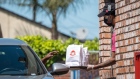 An employee wearing a protective mask and gloves hands an order to a customer at a Wendys Co. restaurant in Richmond, California, U.S., on Wednesday, May 6, 2020. Fast-food chain Wendys Co. jumped the most in a month after reporting that the sales slump caused by the Covid-19 pandemic is easing.
