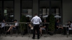 A server take orders from customers at a Toronto restaurant on June 19.