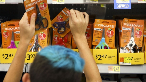 A child browses Fiskars OYJ ABP scissors school supplies displayed for sale at a Wal-Mart Stores Inc. location in Burbank, California, U.S., on Tuesday, Aug. 8, 2017. Wal-Mart Stores is scheduled to release earnings figures on August 17. Photographer: Patrick T. Fallon/Bloomberg