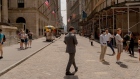Pedestrians on Wall Street near the New York Stock Exchange during the NYSE Summer Series program in New York.