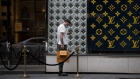 A shopper outside a Louis Vuitton store. Photographer: Christopher Katsarov Luna/Bloomberg