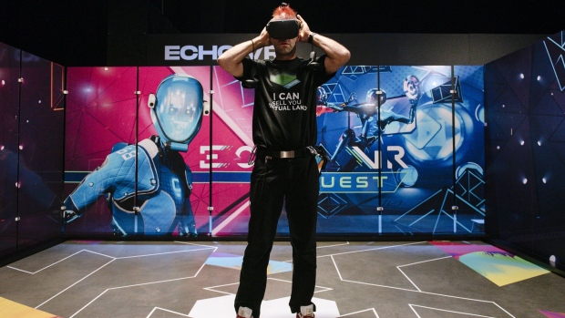 An attendee uses the Oculus VR Inc. Quest virtual reality (VR) headset and controllers during the Oculus Connect 6 conference in San Jose, California, U.S., on Thursday, Sept. 26, 2019. Facebook's virtual reality unit Oculus on Wednesday announced Facebook Horizon, described as an ever-expanding VR world where people can interact with others as digital avatars.