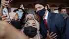 Justin Trudeau takes selfie photographs with worshippers at a mosque in Hamilton, Ontario on July 20.