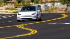 A Tesla Model 3 travels on a road in Rocklin, California. Photographer: David Paul Morris/Bloomberg