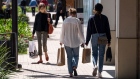 Shoppers wearing protective masks carry bags in the Broadway Plaza Shopping Center in Walnut Creek, California, U.S., on Wednesday, April 14, 2021. U.S. retail sales probably swelled in March thanks to faster hiring, the distribution of federal stimulus checks, a steady pace of Covid-19 vaccinations and fewer restrictions on stores across the country. Photographer: David Paul Morris/Bloomberg