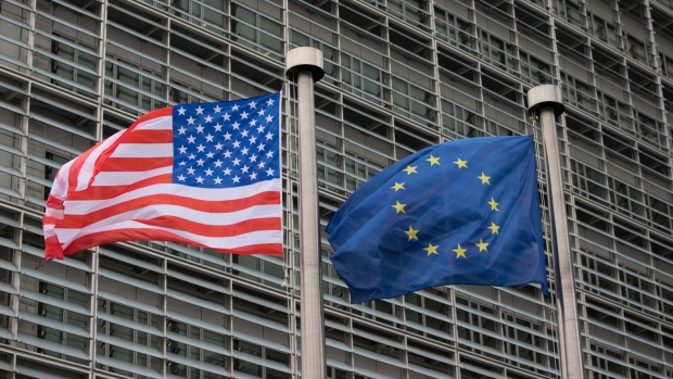 The U.S. national flag, left, flies from a pole beside a European Union (EU) flag outside the European Commission building following a meeting between U.S. Vice President Mike Pence and President of the European Union Donald Tusk in Brussels, Belgium, on Monday, Feb. 20, 2017. Pence flew out of Munich on Sunday leaving America's allies relieved of some of their worst fears about the new administration's foreign policy, yet still uncertain as to who will formulate it. Photographer: Jasper Juinen/Bloomberg