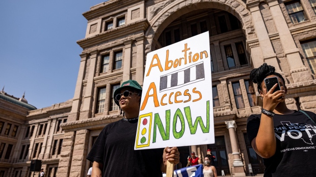 AUSTIN, TX - SEPTEMBER 11: A woman carries a sign calling for access to abortion at a rally at the Texas State Capitol on September 11, 2021 in Austin, Texas. Texas Lawmakers recently passed several pieces of conservative legislation, including SB8, which prohibits abortions in Texas after a fetal heartbeat is detected on an ultrasound, usually between the fifth and sixth weeks of pregnancy. (Photo by Jordan Vonderhaar/Getty Images) Photographer: Jordan Vonderhaar/Getty Images North America