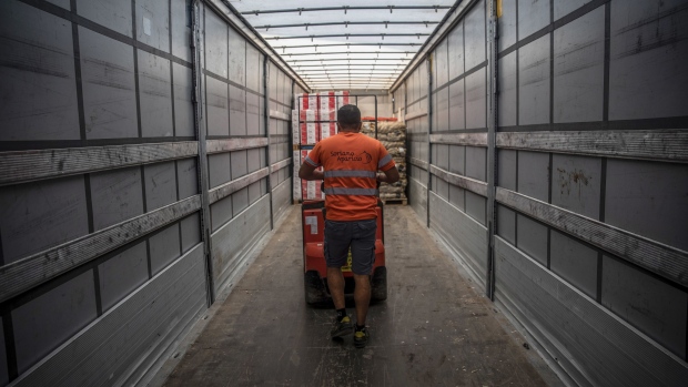 A worker uses a low lift pallet truck to unload goods from a truck in the loading bay at the Mercabarna food wholesale complex in Barcelona, Spain, on Thursday, Sept. 9, 2021. Whether it’s truckers, warehouse operators, chefs or waiters, the global food ecosystem is buckling due to a shortage of staff. Photographer: Angel Garcia/Bloomberg