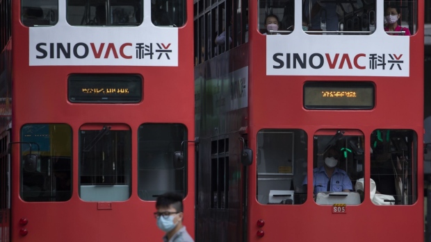 Trams displaying advertisements for Sinovac Biotech in Hong Kong. Photographer: Paul Yeung/Bloomberg