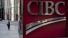 A pedestrian walks past a Canadian Imperial Bank of Commerce (CIBC) sign outside the company's headquarters in the financial district of Toronto, Ontario, Canada, on Wednesday, July 11, 2018. Canadian stocks were mixed Friday as health care tumbled and energy rose, even as was still on pace for a weekly loss amid escalating trade war risks. Photographer: Brent Lewin/Bloomberg