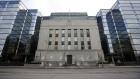A pedestrian walks past the Bank of Canada building in Ottawa.