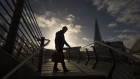 A commuter walks in view The Shard skyscraper in London, U.K., on Monday, Nov. 2, 2020. U.K. Prime Minister Boris Johnson, who on Saturday announced England will enter partial lockdown on Nov. 5, will on Monday try to fend off a looming rebellion from members of his Conservative Party by trying to reassure them the measures will only last four weeks. Photographer: Jason Alden/Bloomberg