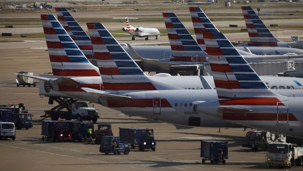 American Airlines Group Inc. airplanes stand at passenger gates at Dallas/Fort Worth International Airport (DFW) near Dallas, Texas.