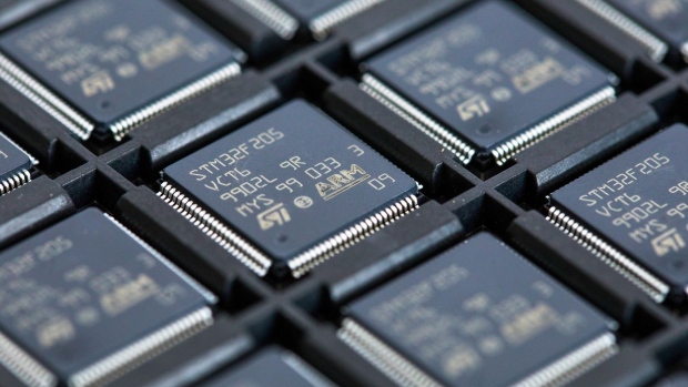 STMicroelectronics STM32F205 integrated circuit microchips (IC's), designed by ARM Ltd., in a storage tray at CSI Electronic Manufacturing Services Ltd. in Witham, U.K.