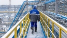 A worker walks along an access platform at the Comprehensive Gas Treatment Unit No.3 of the Gazprom PJSC Chayandinskoye oil, gas and condensate field, a resource base for the Power of Siberia gas pipeline, in the Lensk district of the Sakha Republic, Russia, on Monday, Oct. 11, 2021. Amid record daily swings of as much as 40% in European gas prices, Russian President Vladimir Putin made a calculated intervention to cool the market last week by saying Gazprom can boost supplies to help ease shortages. Photographer: Andrey Rudakov/Bloomberg