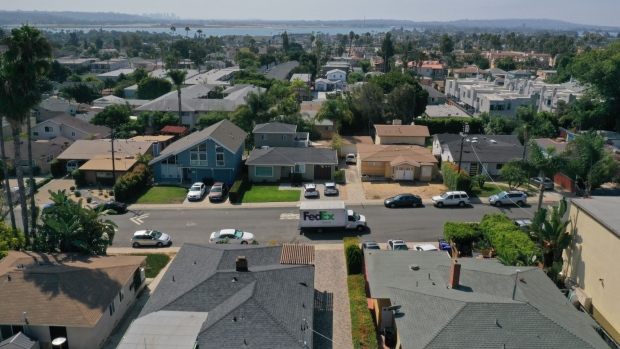 A FedEx Corp. truck drives past homes in this aerial photograph taken over the Pacific Beach neighborhood of San Diego, California, U.S., on Wednesday, Sept. 2, 2020. U.S. sales of previously owned homes surged by the most on record in July as lower mortgage rates continued to power a residential real estate market that's proving a key source of strength for the economic recovery. Photographer: Bing Guan/Bloomberg