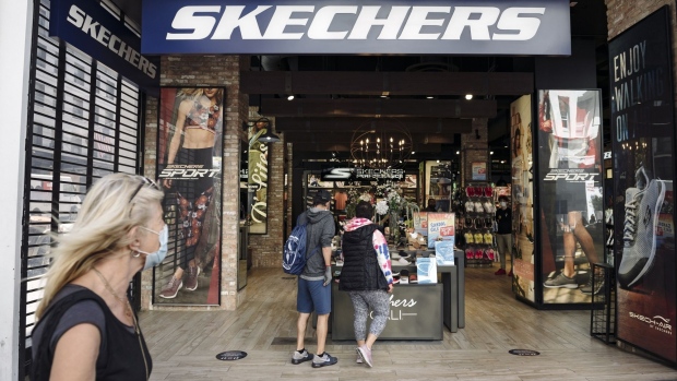 People browse items in a Skechers shoe store in San Francisco, California, U.S., on Thursday, June 18, 2020. San Francisco moved into Phase 2B on Monday, opening up outdoor dining and allowing customers to go inside retail stores to shop.