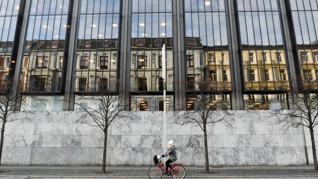 A cyclist passes Denmark's central bank, also know as Danmarks Nationalbank, in Copenhagen, Denmark, on Thursday, Jan. 3, 2019. For the first time in almost three years, the central bank of Denmark has bought kroner to support its euro peg through a direct intervention in the currency market. Photographer: Luke MacGregor/Bloomberg