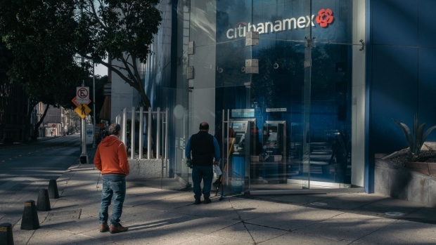 Customers wait in line to use the automatic teller machine (ATM) at a Banco Nacional de Mexico SA (Banamex) Citibanamex bank branch in Mexico City, Mexico, on Wednesday, Jan. 12, 2022. Citigroup Inc. is planning to exit retail-banking operations in Mexico, where it has its largest branch network in the world, as part of Chief Executive Officer Jane Fraser’s continued push to overhaul the firm’s strategy.