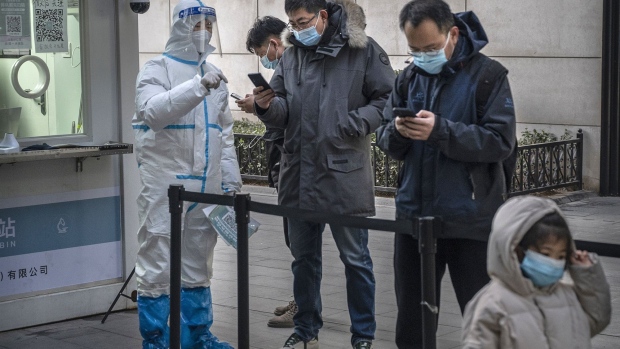 BEIJING, CHINA - JANUARY 17: A health worker wears protective clothing as he helps people register for a nucleic acid test for COVID-19 at a private testing site on January 17, 2022 in Beijing, China. While China has mostly contained the spread of COVID-19 during the pandemic, and even though cases remain relatively low, recent outbreaks of the virus including the emergence of the highly contagious Omicron variant have prompted the government to lockdown nearly 20 million people in various major cities and to reinforce stricter health measures. Mask mandates, mass testing, immunization boosters, quarantines, some travel restrictions and bans and lockdowns have become the norm as China continues to maintain its zero-COVID policy. China's capital city Beijing, has been put on high alert as it prepares to host the Beijing 2022 Winter Olympics and Paralympics which open next month. (Photo by Kevin Frayer/Getty Images)