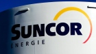 Suncor Energy Inc. signage is displayed on a petroleum storage tank in Montreal, Quebec, Canada, on Sunday, Nov. 6, 2011.