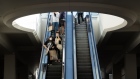 Shoppers ride an escalator at the Fashion Valley shopping mall in San Diego Photographer: Bing Guan/Bloomberg