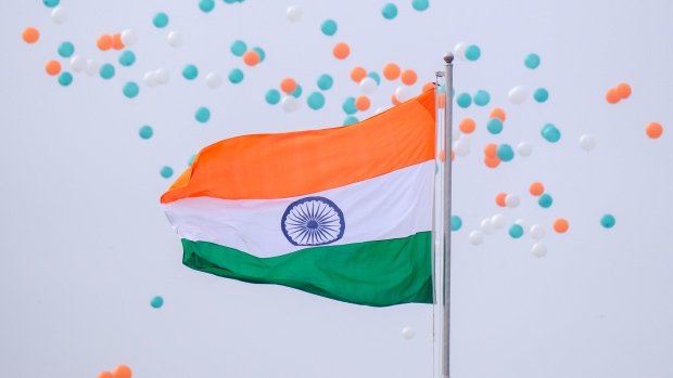 Balloons float past an Indian national flag during the Republic Day parade in New Delhi, India, on Wednesday, Jan. 26, 2022. India has bounced back strongly from the pandemic and stands poised to claim the mantle of fastest-growing economy in 2021 and probably 2022 as well. Photographer: T. Narayan/Bloomberg