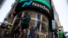 Pedestrians in front of the Nasdaq MarketSite in New York, US, on Wednesday, June 15, 2022. Stocks climbed, Treasury yields tumbled and the dollar pushed lower after Federal Reserve Chair Jerome Powell signaled outsized rate hikes will be rare as officials intensify their battle against rampant inflation.