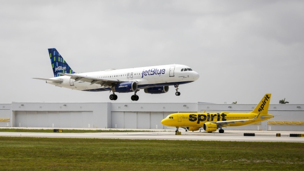 JetBlue and Spirit airplanes at Fort Lauderdale-Hollywood International Airport (FLL) in Fort Lauderdale, Florida, US, on Saturday, May 21, 2022. Spirit Airlines Inc. rebuffed a hostile $3.3 billion takeover offer from JetBlue Airways Corp., setting the stage for a potentially contentious vote by shareholders on whether to back the bid or go with a competing proposal from Frontier Group Holdings Inc. Photographer: Eva Marie Uzcategui/Bloomberg