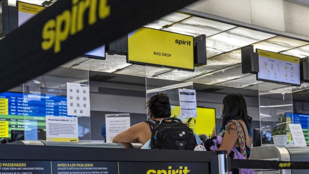Travelers at a Spirit Airlines check in counter at the Oakland International Airport in Oakland, California, U.S., on Tuesday, Jun. 21, 2022. JetBlue Airways Corp. raised its offer to purchase Spirit Airlines Inc., the latest move in a multi-billion dollar takeover contest with rival Frontier Group Holdings Inc., with both would-be suitors battling to secure a swift track to expansion as domestic travel demand surges.