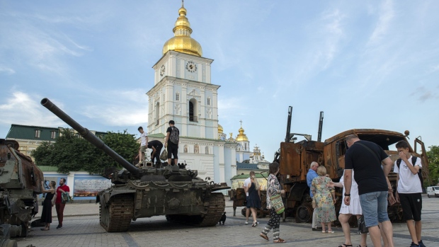 Visitors look round a destroyed Russian tank and other military equipment displayed at St. Michael's Square in Kyiv, Ukraine, on Monday, June 27, 2022. The North Atlantic Treaty Organization (NATO) announced a plan to boost the size of its high-readiness force to 300,000 as it implements a fundamental shift in its deterrence plans after Russia's invasion of Ukraine.