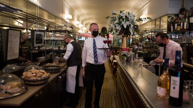 Waiters work inside the Savy restaurant on Rue Bayard in Paris, France, on Friday, Jan. 28, 2022. Local businesses in Paris's 8th arrondissement are looking forward to a new crowd of well-paid customers as New York-based Millennium has leased space in the RTL radio station's old headquarters on Rue Bayard, just around the corner from the gleaming luxury stores of Avenue Montaigne. Photographer: Nathan Laine/Bloomberg