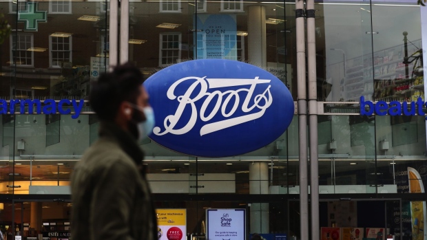 A pedestrian wearing a protective face mask passes a Boots pharmacists, operated by Walgreens Boots Alliance Inc., on Oxford Street in London, U.K., on Thursday, July 9, 2020. British shops aren't getting much of a boost from newly reopened bars, cafes and restaurants as customers prefer to stay away. Photographer: Simon Dawson/Bloomberg