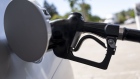A fuel nozzle in a car at a Chevron gas station in Pinole, California, U.S., on Wednesday, June 22, 2022. President Joe Biden called on Congress to suspend the federal gasoline tax, a largely symbolic move by an embattled president running out of options to ease pump prices weighing on his party's political prospects.