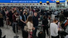 Passengers queue to check in at British Airways desks inside the departures hall of Terminal 5 at London Heathrow Airport in London, U.K., on Wednesday, April 13, 2022. Travel disruption continued to hit U.K. holidaymakers as officials warned of expected queues at airports later in the week and motorists faced fuel shortages.