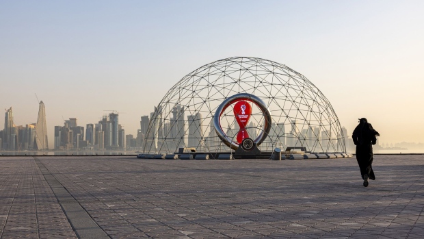A resident jogs alongside a countdown installation for the upcoming 2022 FIFA World Cup in Doha, Qatar, on Thursday, June 23, 2022. About 1.5 million fans, a little more than half the population of Qatar, are expected to descend upon the tiny Gulf state for this year's FIFA World Cup football tournament.
